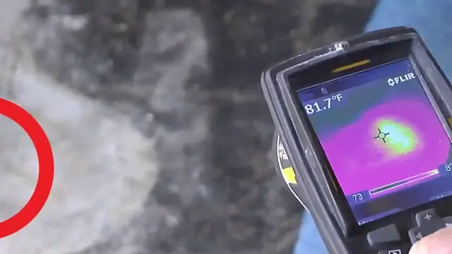 Thermal imaging camera showing a heat pattern over a concrete surface